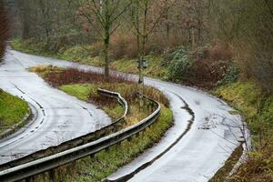 unused industrial road in poor condition in the rain photo