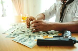 Businessman with money, cards, alcohol and gun, financial and gambling problems, Stressful gambling addicts are experiencing financial problems and bankruptcy. photo