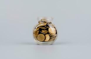 Saving money coins in a glass bottle Concepts of saving money, cash flow, assets and real estate. financial investment coin bank photo