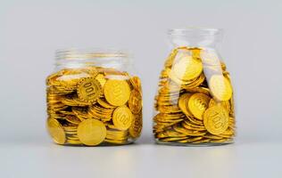 Saving gold coins in glass bottles, gold stocks, investing in gold, high value assets. photo