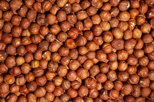 Scattered Peeled Hazelnut - Top View. Background from Hazelnuts. Natural High-Calorie Snacks photo