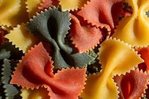 Uncooked Vibrant Colored Farfalle Pasta. A Culinary Canvas of Multicolored Bow-Tie Macaroni, Creating a Lively and Textured Background for Gourmet Cooking Enthusiasts. Colored Dry Pasta. Raw Macaroni photo
