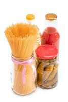 Food Reserves. Canned Food, Spaghetti, Pickles and Tomato Juice - Isolated on White Background. Emergency Food Storage in Case of Crisis. Strategic Food Supplies - Isolation photo