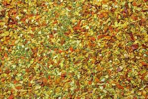 Vibrant and Colored Vegetable Seasoning Mix. A Culinary Canvas of Aromatic Seasoning - Textured Background for Gourmet Cooking. The Harmonious Combination of Fresh Herbs and Spices - Top View photo