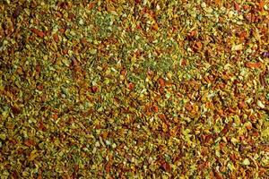 Vibrant and Colored Vegetable Seasoning Mix. A Culinary Canvas of Aromatic Seasoning - Textured Background for Gourmet Cooking. The Harmonious Combination of Fresh Herbs and Spices - Top View photo