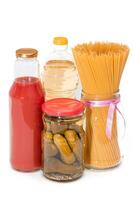 Food Reserves. Canned Food, Spaghetti, Pickles and Tomato Juice - Isolated on White Background. Emergency Food Storage in Case of Crisis. Strategic Food Supplies - Isolation photo