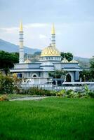 Indonesian Islamic mosque located among rice fields. photo