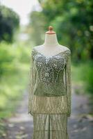 Dress Details. Green wedding dress on mannequin. photo