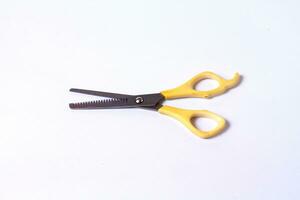 Yellow sasak scissors on a white background photo