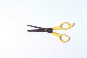 Yellow sasak scissors on a white background photo