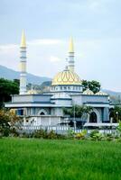 Indonesian Islamic mosque located among rice fields. photo