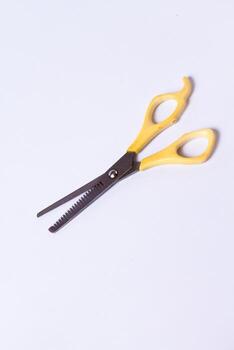 Yellow sasak scissors on a white background photo