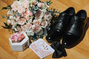 Groom's suit and details, men's details. wedding rings, men's bow tie, black leather men's shoes photo