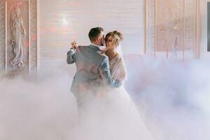 novios felices y su primer baile, boda en el elegante restaurante con una luz y un ambiente maravillosos foto