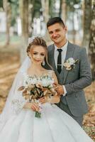 bride and groom on the background of a fairy-tale forest. Royal wedding concept. the groom embraces the bride. Tenderness and calmness. Portrait photo