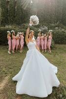 Group portrait of bride and bridesmaids. Wedding. Bride in wedding dress and bridesmaids in white dresses at wedding day. Stylish wedding in white color. Marriage concept. photo