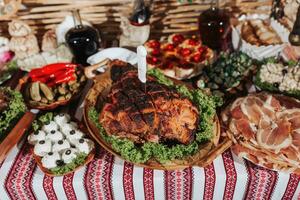 Snacks at the wedding, cheese, sausage, vegetables, meat products, Cossack table at the Ukrainian wedding. photo