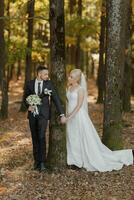 bride and groom on the background of a fairy-tale forest. Romantic views, promotional photo Wedding couple holding hands, stylish wristwatch