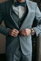 cropped photo of a stylish man adjusting his jacket. Front view. A stylish watch. Men's style. Fashion. Business
