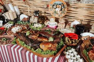 Snacks at the wedding, cheese, sausage, vegetables, meat products, Cossack table at the Ukrainian wedding. photo