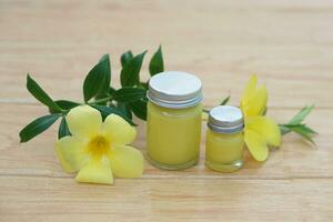 Bottles of homemade Thai herbal ointment and inhaler.Decorated with yellow flower. Concept, Thai local wisdom to use fragrant medicinal herbs to make inhaler and massage balm. photo