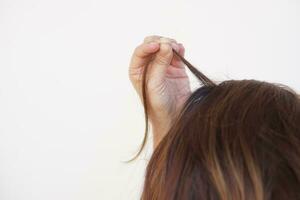 Close up woman hand is pull her hair up. Concept, Hair pulling disorder or Trichotillomania. Mental health.Psycho problems. photo