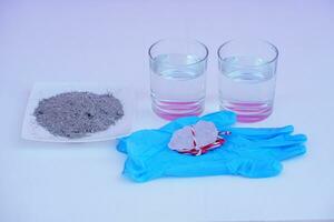 Equipment for doing science experiment about sedimentation by using alum stone with ash water in glass.Concept, Education, Easy activity lesson for kids. Reaction of chemical substance in alum stone. photo