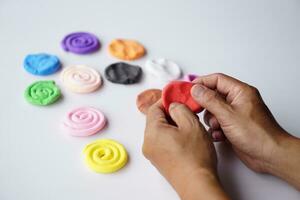 Close up hands sculpt plasticine into different shapes. Concept, alzheimer. weak muscle patients recovering activity by sculpting. Make concentration for ADHD or autistic symptom kids. Enhance imagine photo