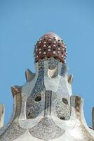 pyramid of a bizarre shape, a lotus, in the blue sky, decorated with a pattern of ceramic tiles photo