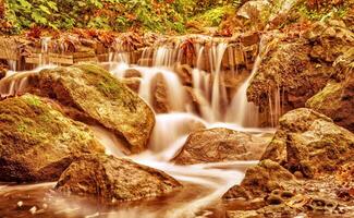 Beautiful waterfall in autumn park photo
