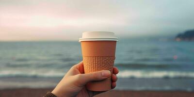 AI generated A Person Hand Holding a Paper Coffee Cup with Beach View. Generative AI photo