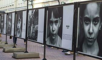 Moscow, Russia - 07.24.2023 - Photographs of the kids from the war zone placed on the Arbat street . City photo