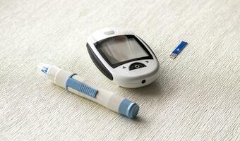 Close up shot of the glucometer instrument on the white surface. Healthcare photo