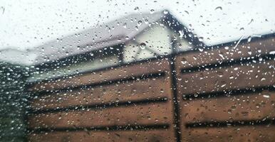 Concept shot of the car window covered by rain drops. Background photo