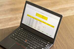 Laptop showing an excel sheet on the screen with bank loan amortization table. Finance photo