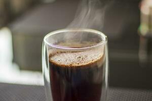 Disparo de el caliente agua vertido dentro el transparente taza a elaborar cerveza el café. bebida foto
