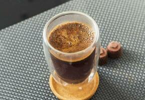 Shot of the hot water poured into the transparent cup to brew the coffee. Beverage photo