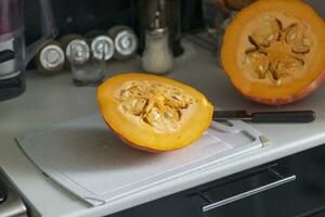 Close up shot of the cut pumpkin on the table. Vegetable photo