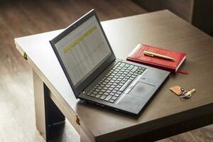 Laptop showing an excel sheet on the screen with bank loan amortization table. Finance photo