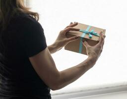 Close up shot of the woman holding rapped gift box photo