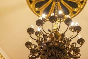 Close up shot of the decorative walls, ceiling and chandelier. Interior photo