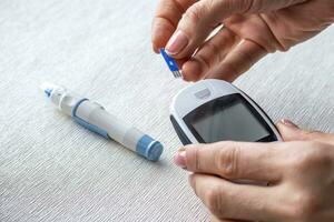 Close up shot of the glucometer instrument on the white surface. Healthcare photo