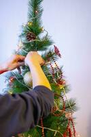 Close up shot of woman decorating christmas tree. Holiday photo