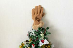 Close up shot of new year decorations. Glove placed on the top of the christmas tree for fun. Holidays photo