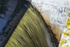 Shot of the dirty, industrial water falling. Background photo