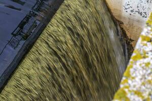 Shot of the dirty, industrial water falling. Background photo