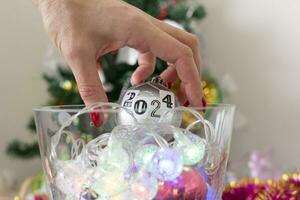 Close up shot of woman decorating christmas tree. New year changing numbers. Holiday photo