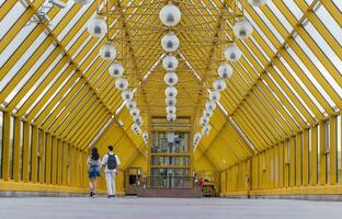 People crossing pedestrian bridge. Conceptual photo