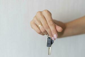 Close up shot of the woman's hand holding a key. Concept photo