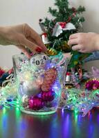 Close up shot of woman and little boy decorating christmas tree. New year changing numbers. Holiday photo